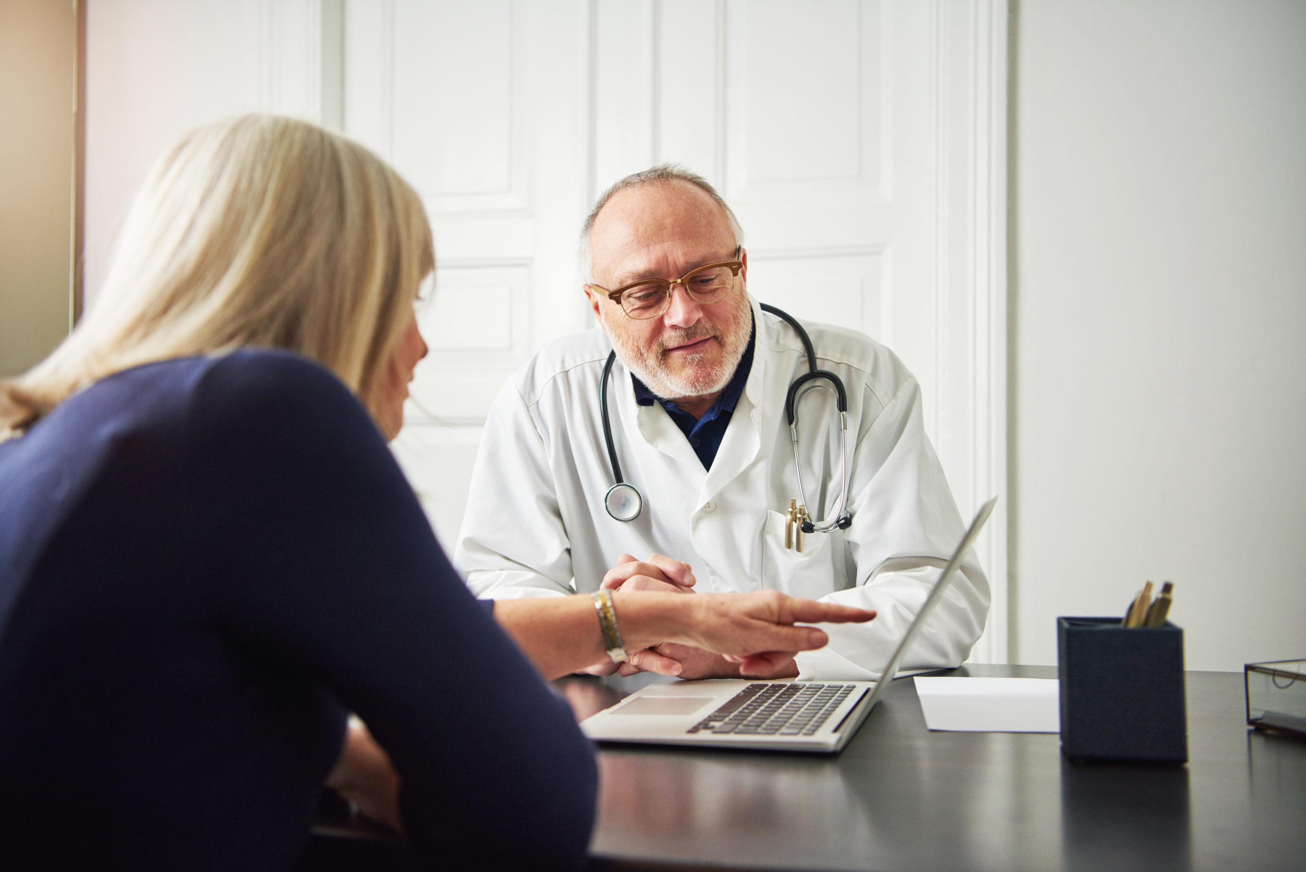 female-patient-consulting-with-medic-at-computer